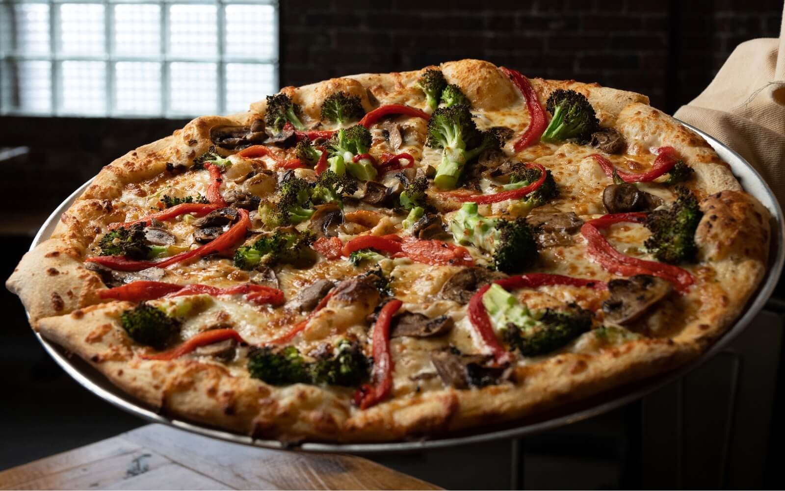 pizza with brocolli, mushrooms, red peppers